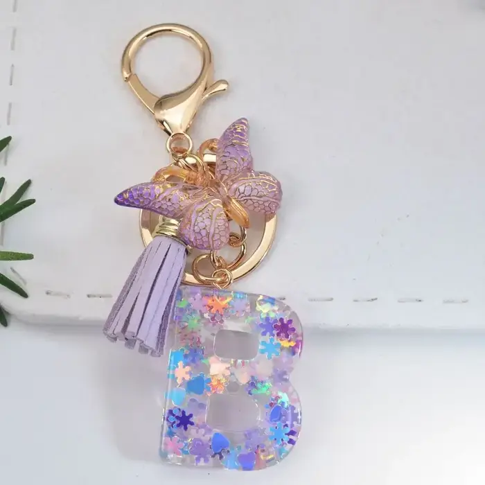 Porte-clés Alphabet A à Z 26 lettres, avec initiales, flocons de neige violets, pompon et sequins